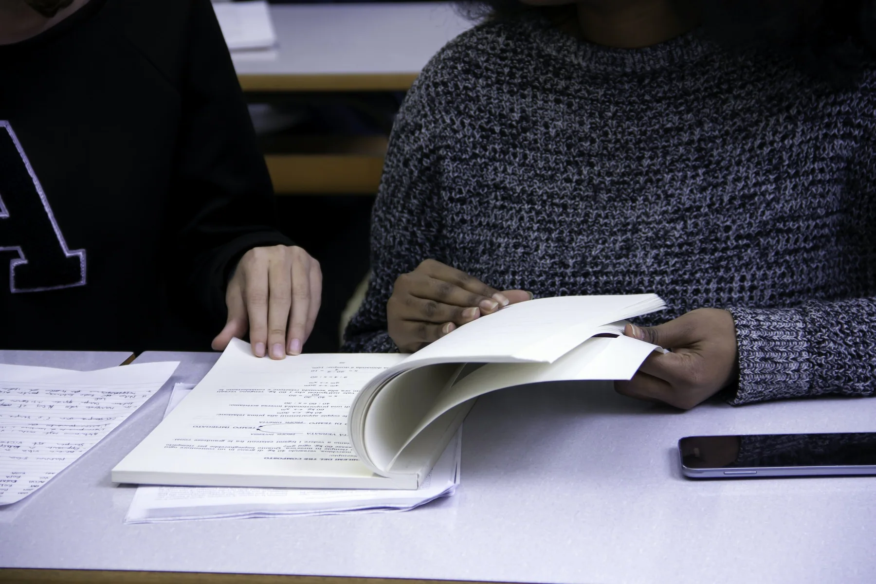 Open notebook with a pen on a wooden table